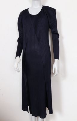 le mannequin porte une robe noire à manches longues
