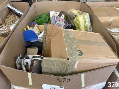 a cardboard box filled with assorted items in a room