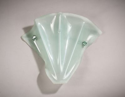 a glass wall sconce on a white wall