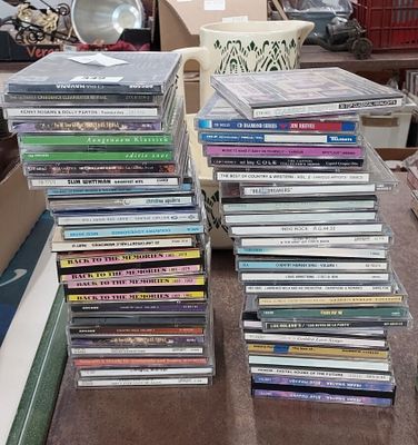 many dvds stacked on top of each other on the floor