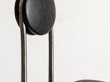 the back of a black chair with a black seat and back rest