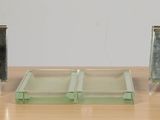 three small glass boxes sitting on a wooden table