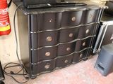 a laptop sitting on top of a chest of drawers