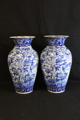 two blue and white vases sitting next to each other