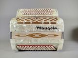 a close up of a white accordion on a table