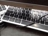 a computer keyboard and a mouse on a desk