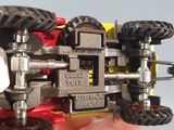 a person holding a toy tractor in their hand