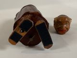 a small wooden box with a face on it next to a small wooden box with a face on it