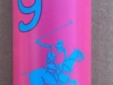 a pink bottle with a blue lid sitting on a wall
