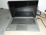 a laptop that is sitting on a table with a charger