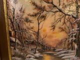 a picture of a painting of a winter scene on the wall