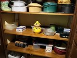 many pots and pans on the shelves in the kitchen