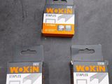 three boxes of wokin staples on a table next to a box of staples
