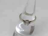 a ring that is sitting on top of a clear glass