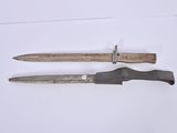 two knives that are laying on a white surface