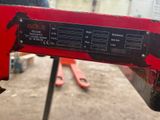 a close up of a red machine on a table