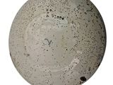 a white plate with black dots on it on a white background