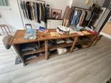 a large wooden table with clothes on it in a room