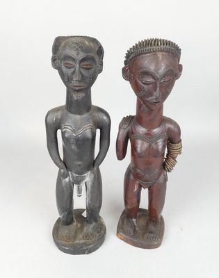 pair of african carved wooden figures of a man and a woman