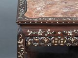 a wooden table with a marble top on it