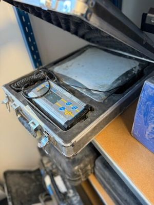une étagère métallique sur laquelle sont posés un écran et un ordinateur portable