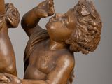 a statue of a boy and a girl holding grapes