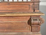 a wooden bench with a decorative railing on top of it