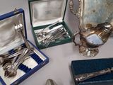 silver spoons and silverware in a box on a table