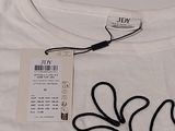 a white t - shirt with a black cord attached to it