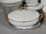 a lot of plates and bowls that are sitting on a table