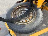 a close up of a tire with a tire chain attached to it