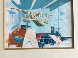 two framed pictures of a plane and a plane in a room