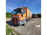 a large orange truck parked in a parking lot