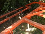 an orange metal structure that is sitting in the grass