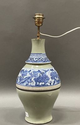 an image of a blue and white vase with a light on top of it