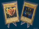 two pokemon cards on display on a blue background