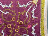 a close up of a scarf with chains and chains on it