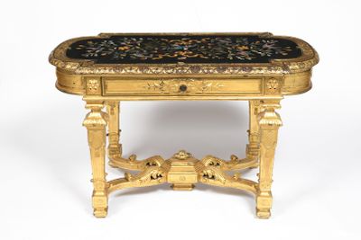 a gold table with a black marble top on a white background