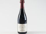 the bottle of wine is sitting on a white surface