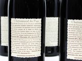 several bottles of wine are lined up on a white surface