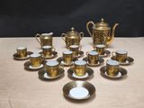 many cups and saucers sitting on a table