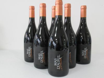 six bottles of red wine are lined up on a table