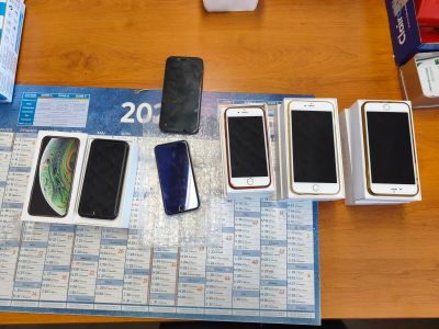 several cell phones are sitting on a table next to a calendar