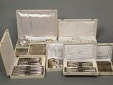 many silverware items in a case on the table
