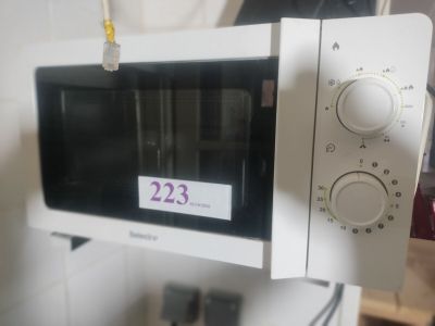 a white microwave oven sitting on top of a white counter