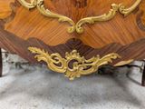 a wooden cabinet with a gold decoration on it