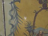 a painting on the wall of a room with a man fishing