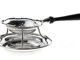 a silver saucer with a black handle on a white background