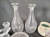 two clear glass vases sitting next to each other