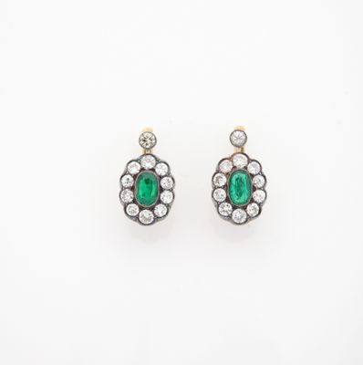 a pair of emerald and diamond earrings